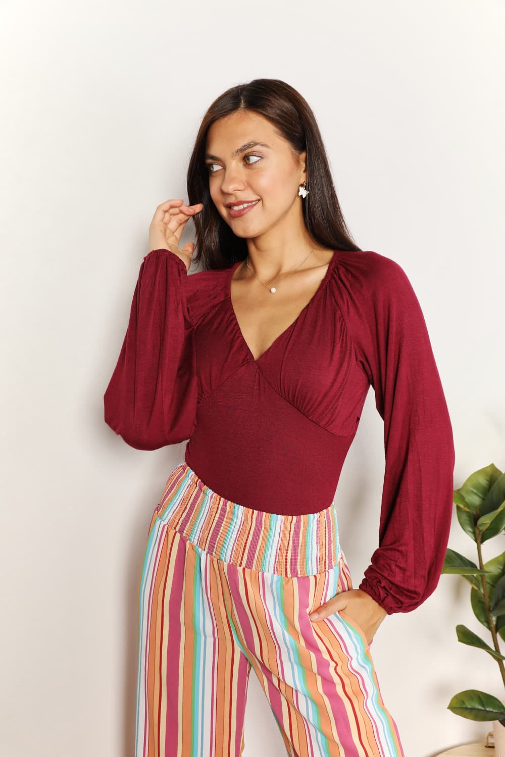 Sophisticated Romance: V-neck Bodysuit with Dramatic Poet Sleeves