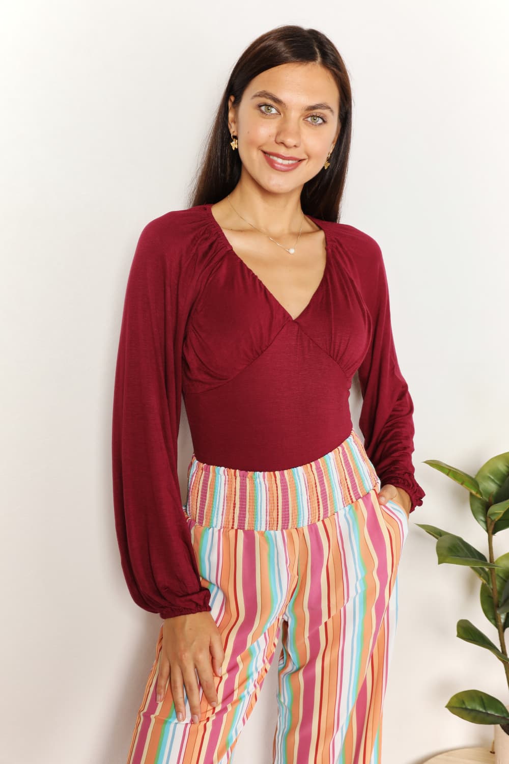 Sophisticated Romance: V-neck Bodysuit with Dramatic Poet Sleeves